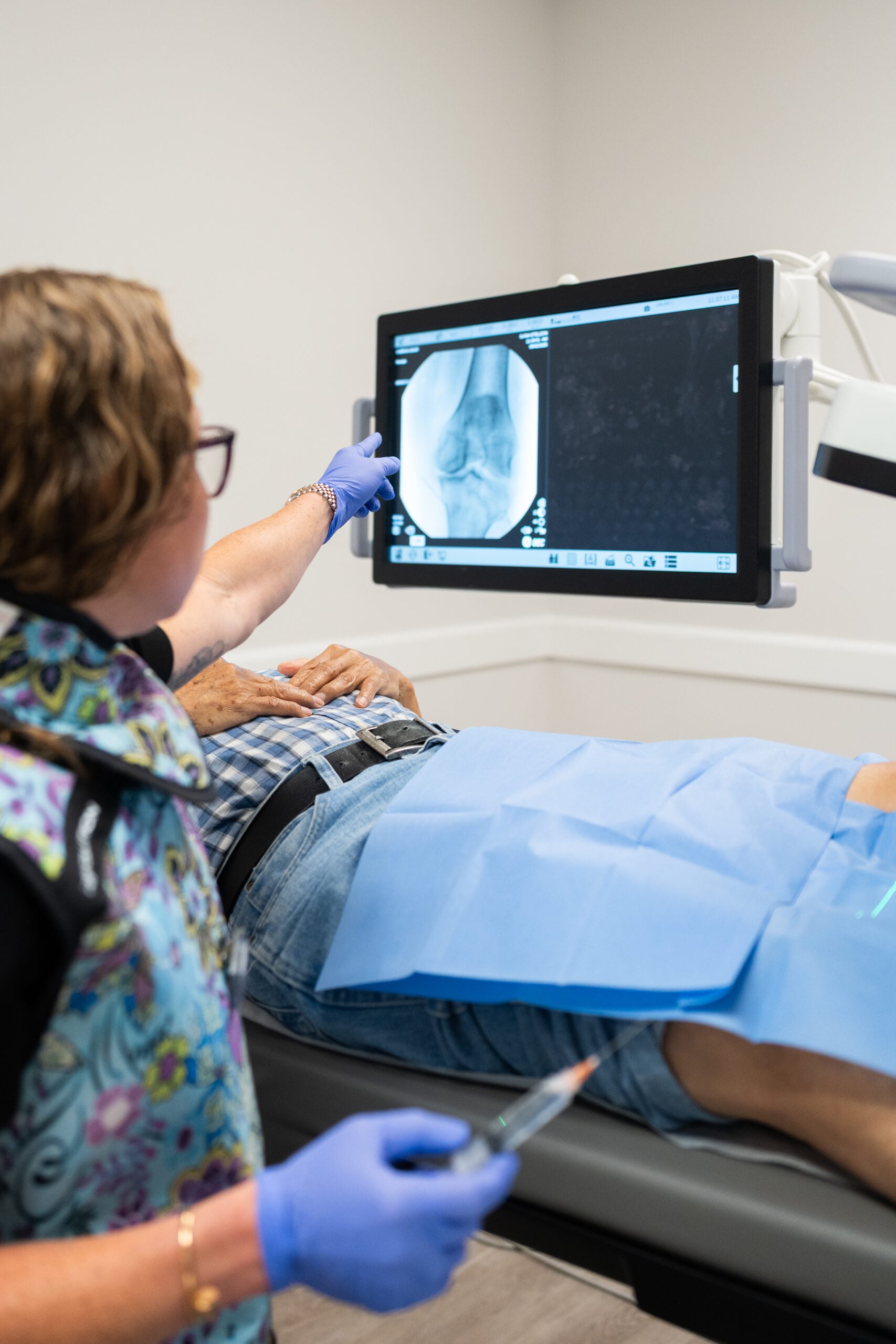 Clinician reviewing live fluoroscopy imaging during an image-guided injection at Pain Doctors Medical