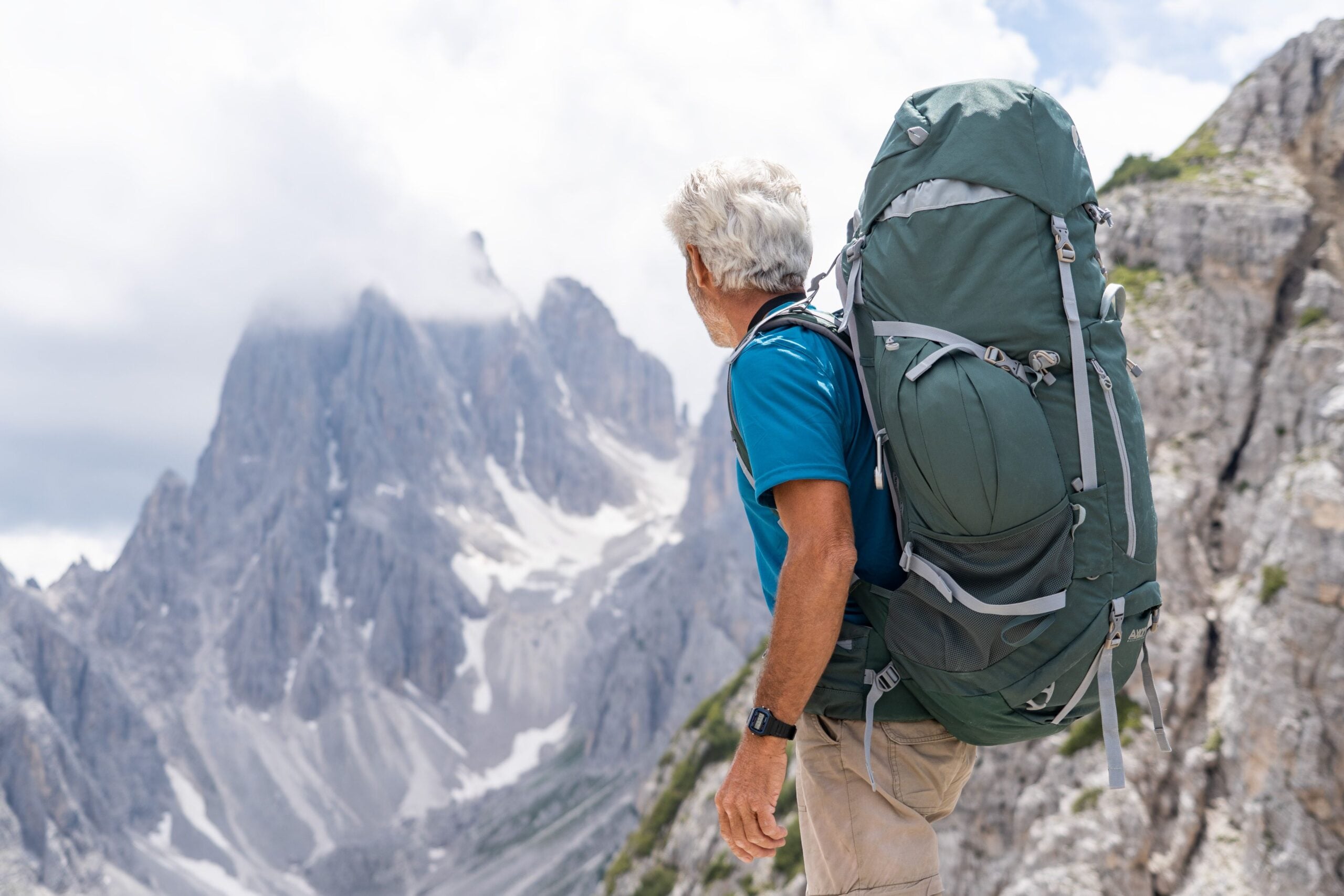 Man hiking in the mountains, active and strong after regenerative medicine at Pain Doctors Medical