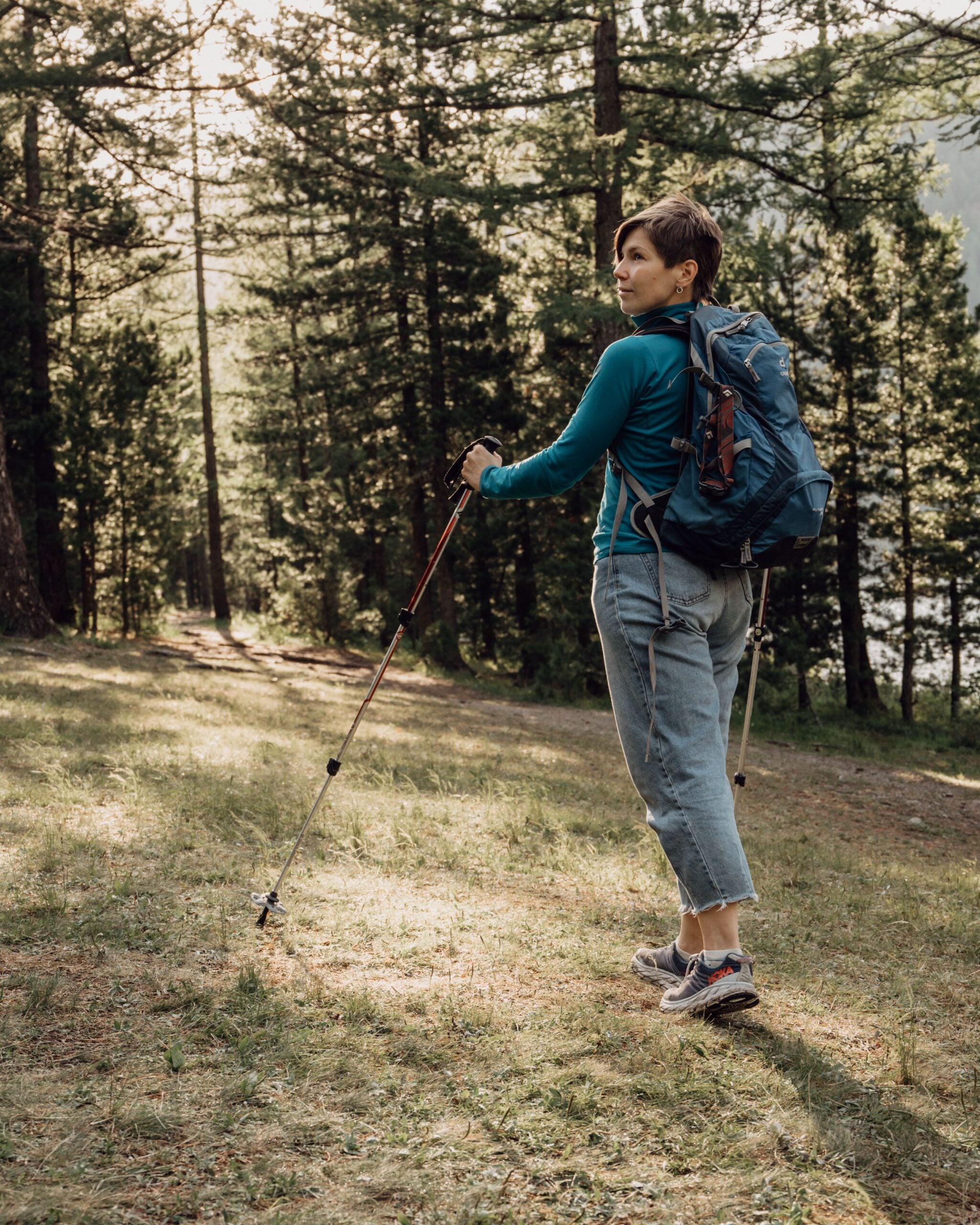 Woman hiking a forest trail after regenerative medicine treatment at Pain Doctors Medical
